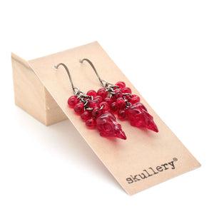 raspberry skull earrings